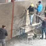 plastering wall in warehouse