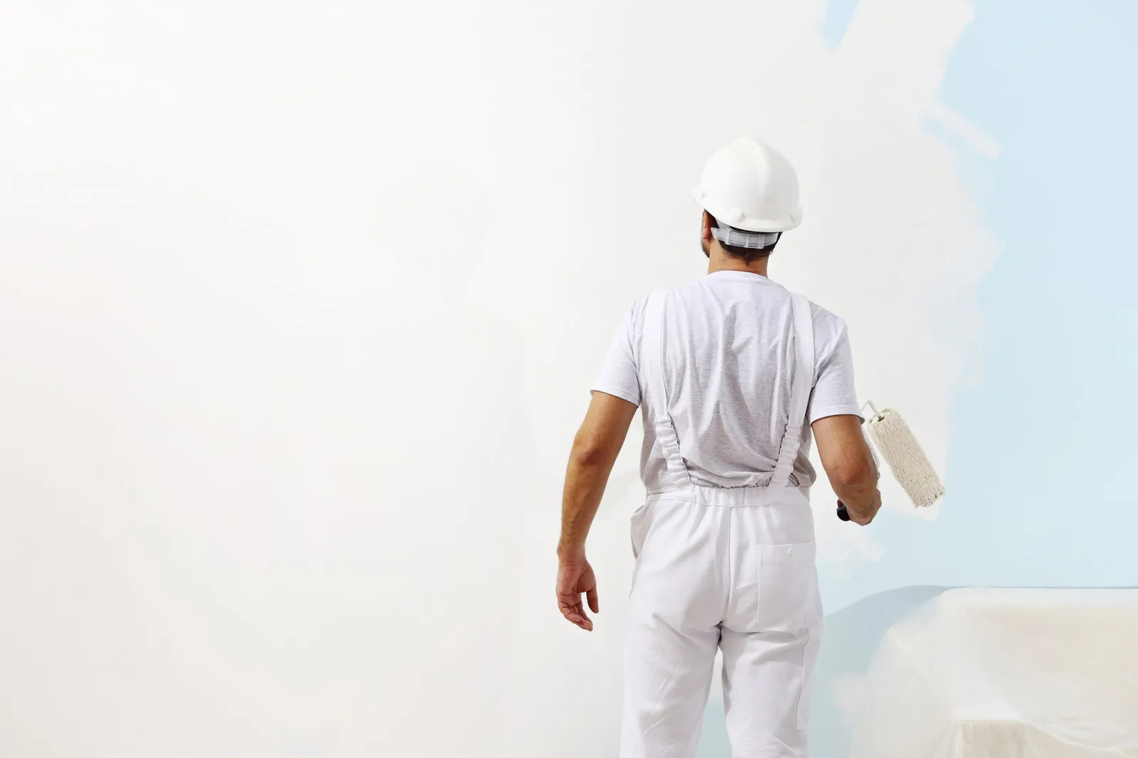 decorator painting light blue wall white