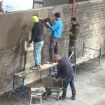 plastering wall in warehouse