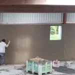 plastering wall in warehouse