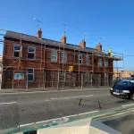 Roof repairs on row of red bricked houses