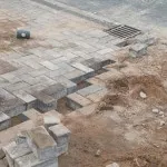 laying ground bricks in forecourt