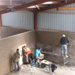 plastering wall in warehouse