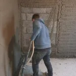 plastering wall in warehouse