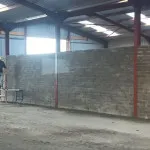 plastering wall in warehouse